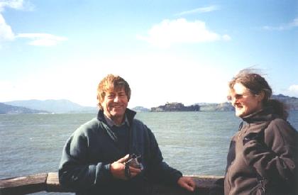2002-03-17 1a Adrian & Margaret Massialas by pier 39 San Francisco with Alcatraz behind, California